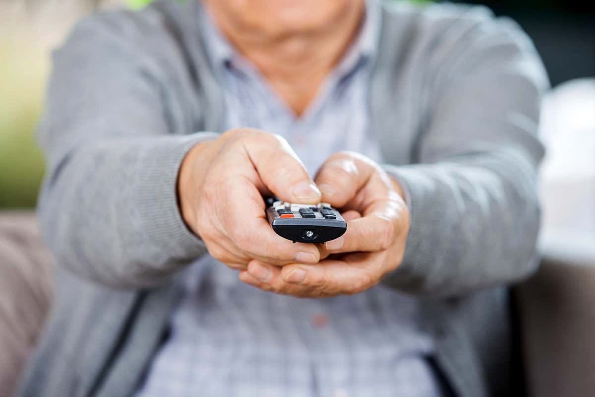 A person holding a remote