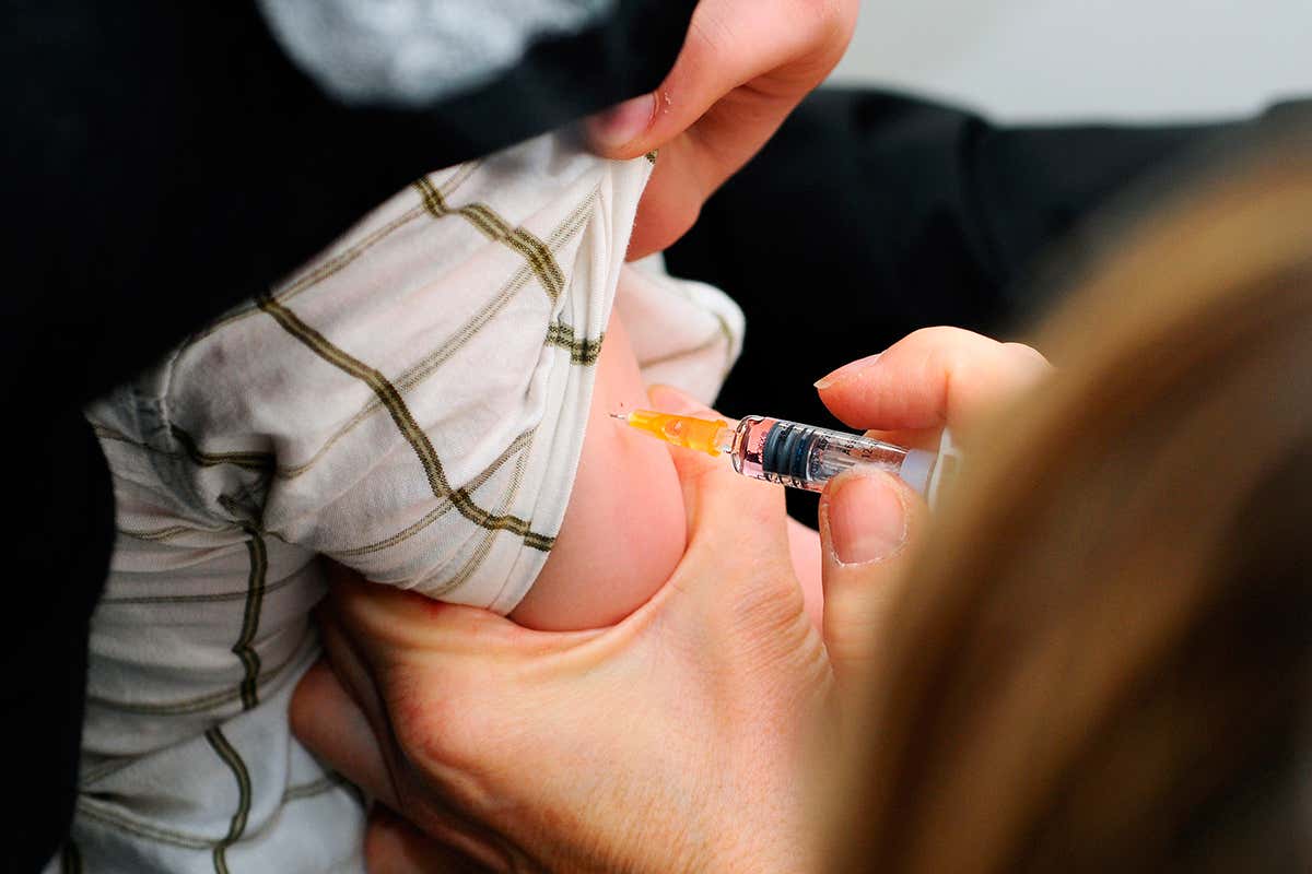 Child receives measles injection