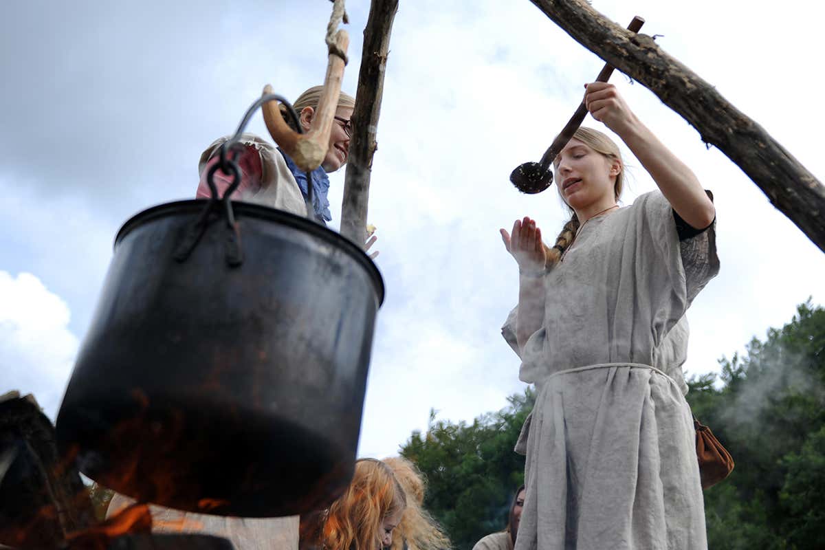 Students prepare a stew over an open fire at the stone age park near Albersdorf, Germany. Students of the University of Hamburg took on the roles of people from the stone age as part of one of their classes
