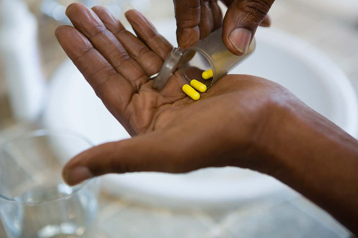 Tipping pills into hand