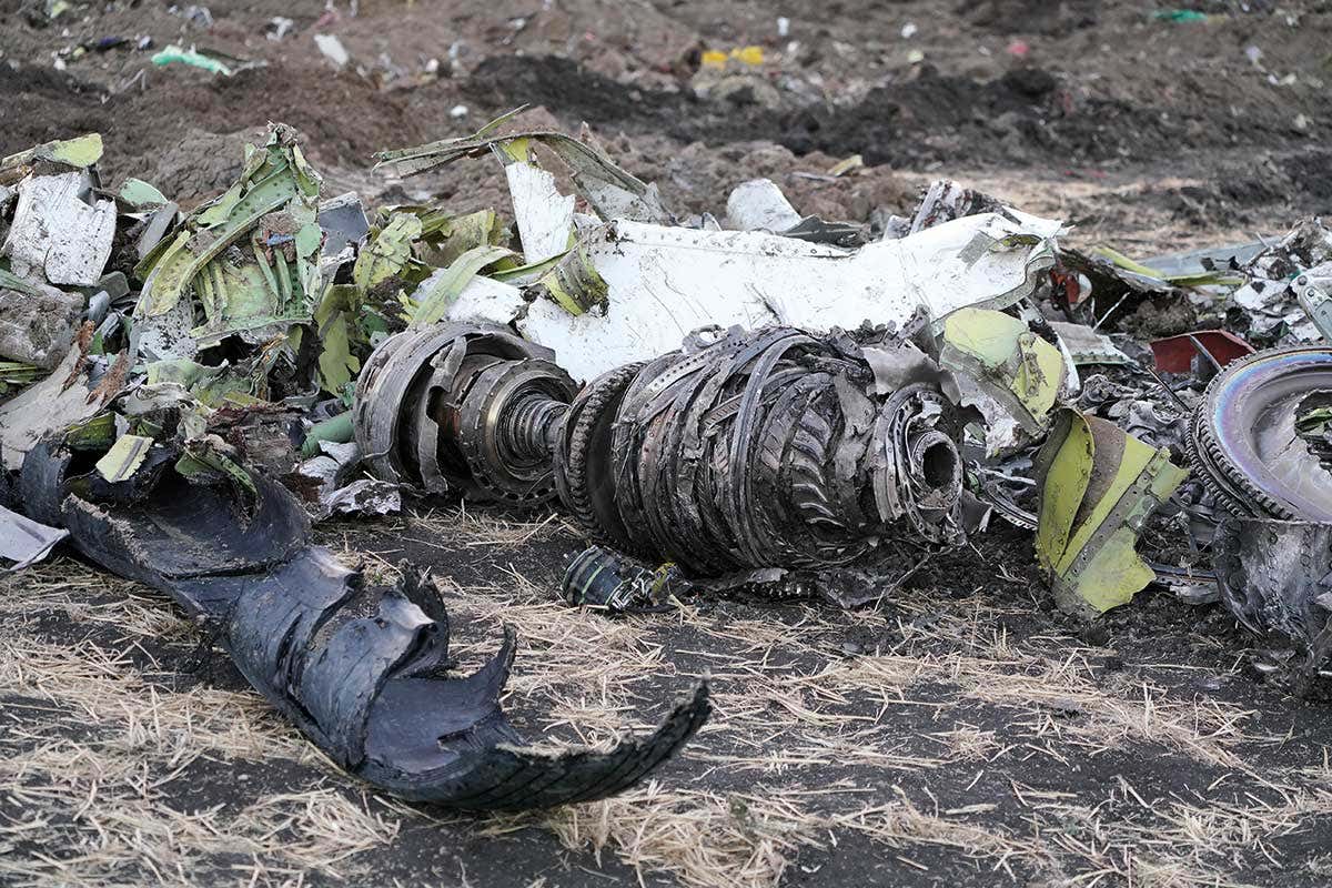 arts of an engine and landing gear lie in a pile after being gathered by workers during the continuing recovery efforts at the crash site of Ethiopian Airlines flight ET302
