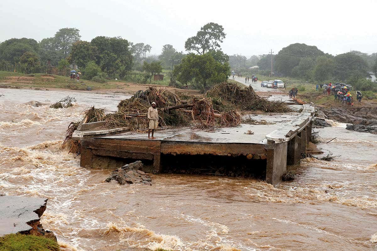 A man on the remains of a bridge in Zimbabwe