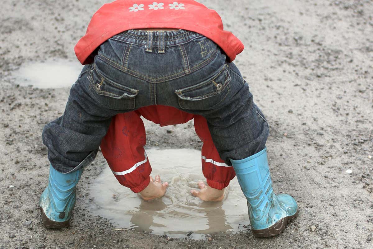 A child playing in the mud