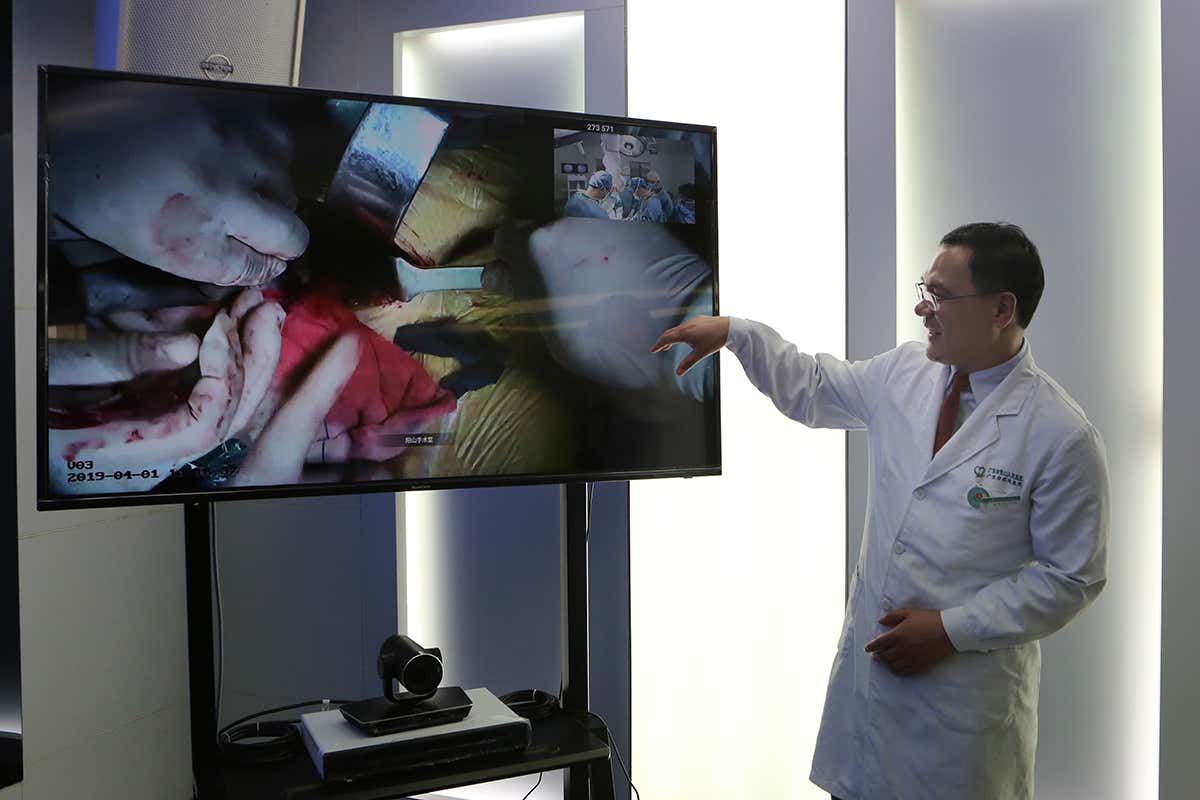 Qi Yong of the Second People's Hospital supervises a surgery performed at Yanshan Hospital through a 4K UHD live broadcast on April 1, 2019 in Guangzhou, Guangdong Province of China.