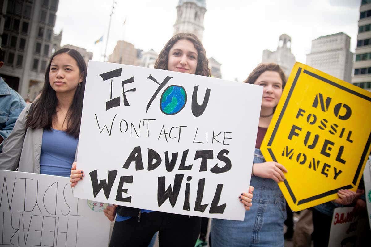 Girl holding poster that says