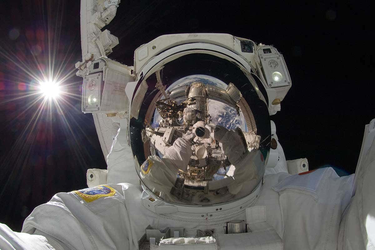 As astronaut's helmet reflecting a spaceship