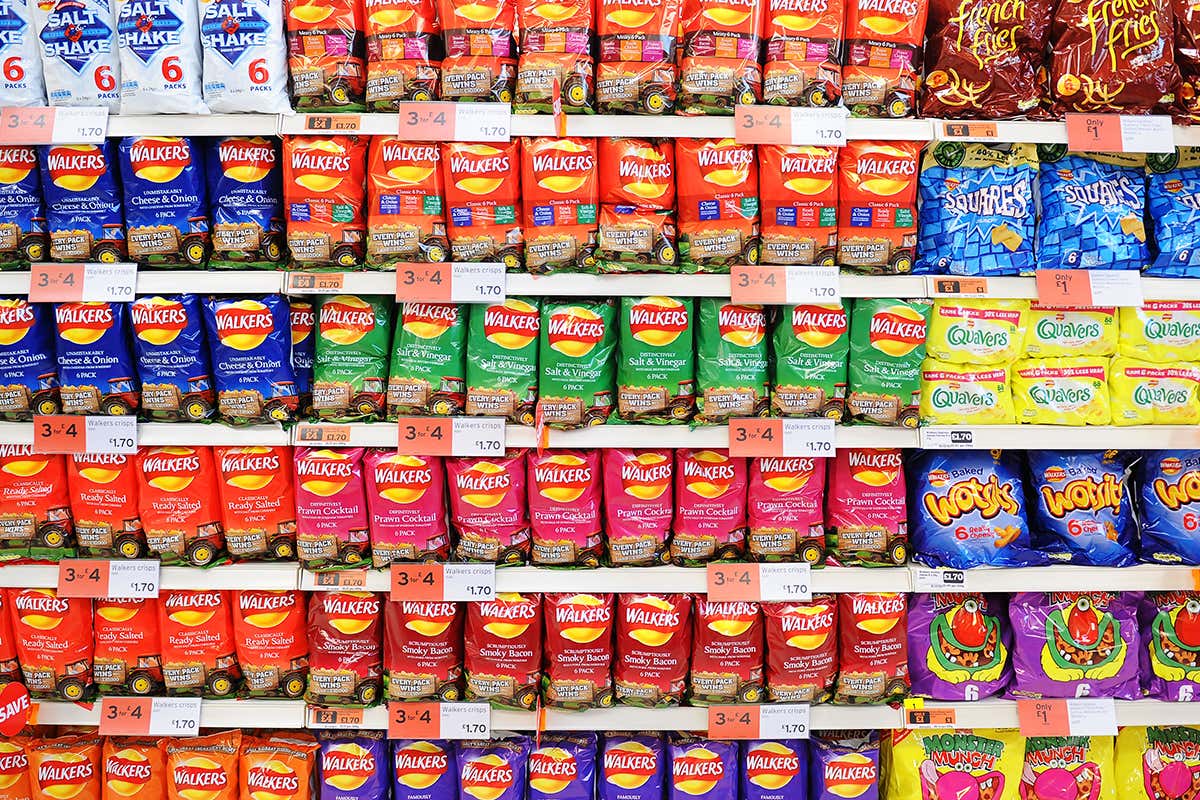 Shelves full of Walkers crisps