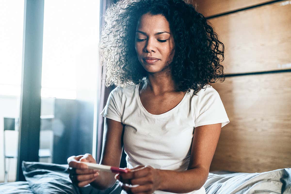 A person looks at a pregnancy test