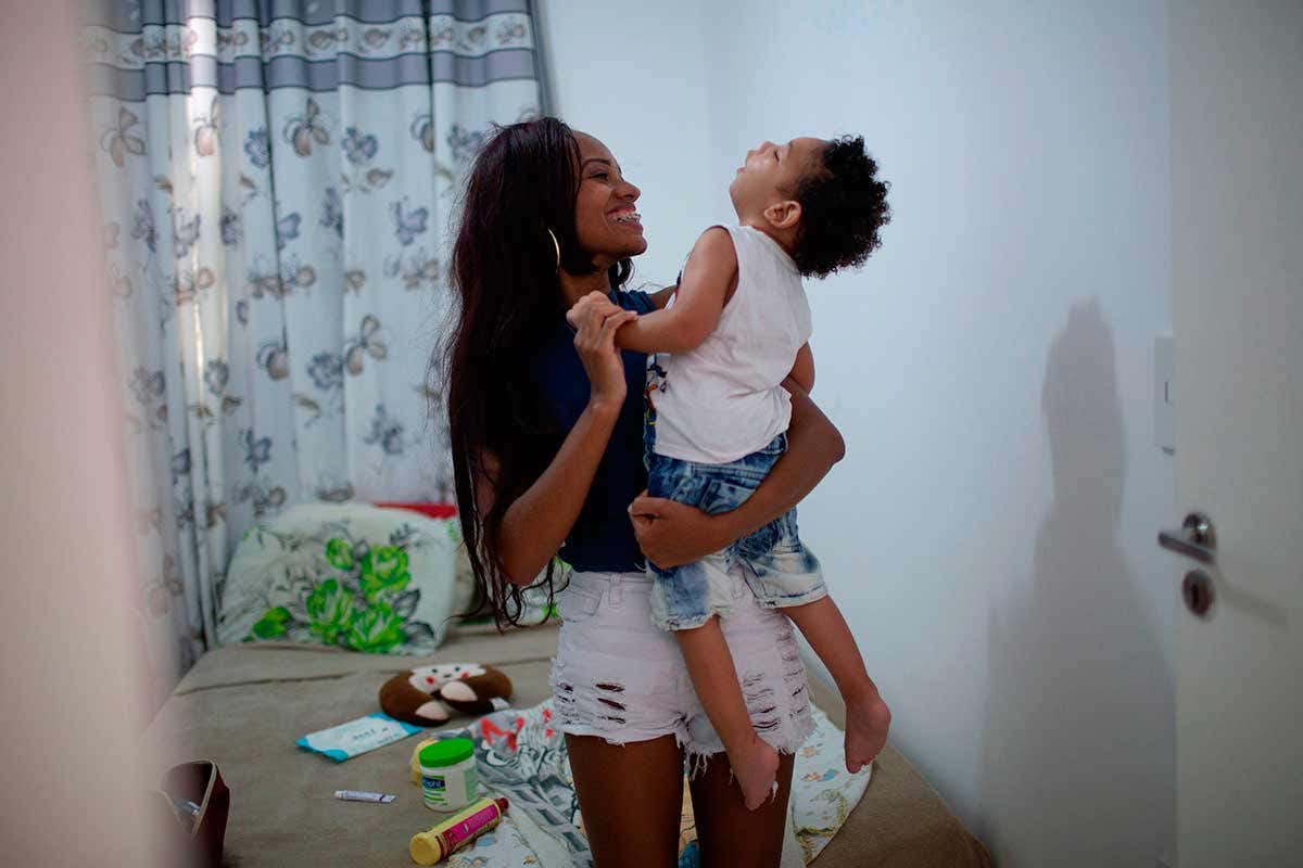 Brazilian Thamires Cristina dos Santos Ferreira da Silva, 29, plays with her two-year-old son Matheus Silva, who was born with microcephaly, at their apartment in Belford Roxo, Rio de Janeiro State, Brazil, on November 30, 2018.
