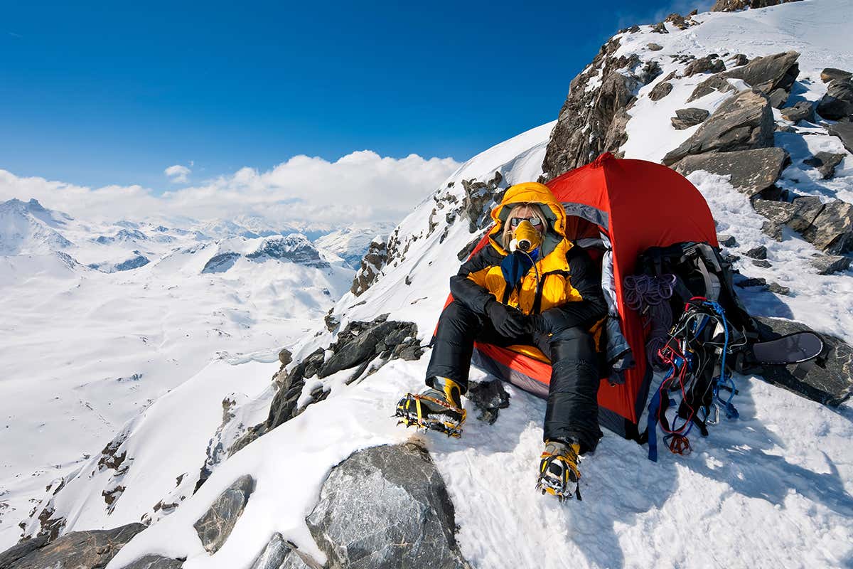 Hypoxia - A climber in tent at very high altitude with oxygen breathing appartus.