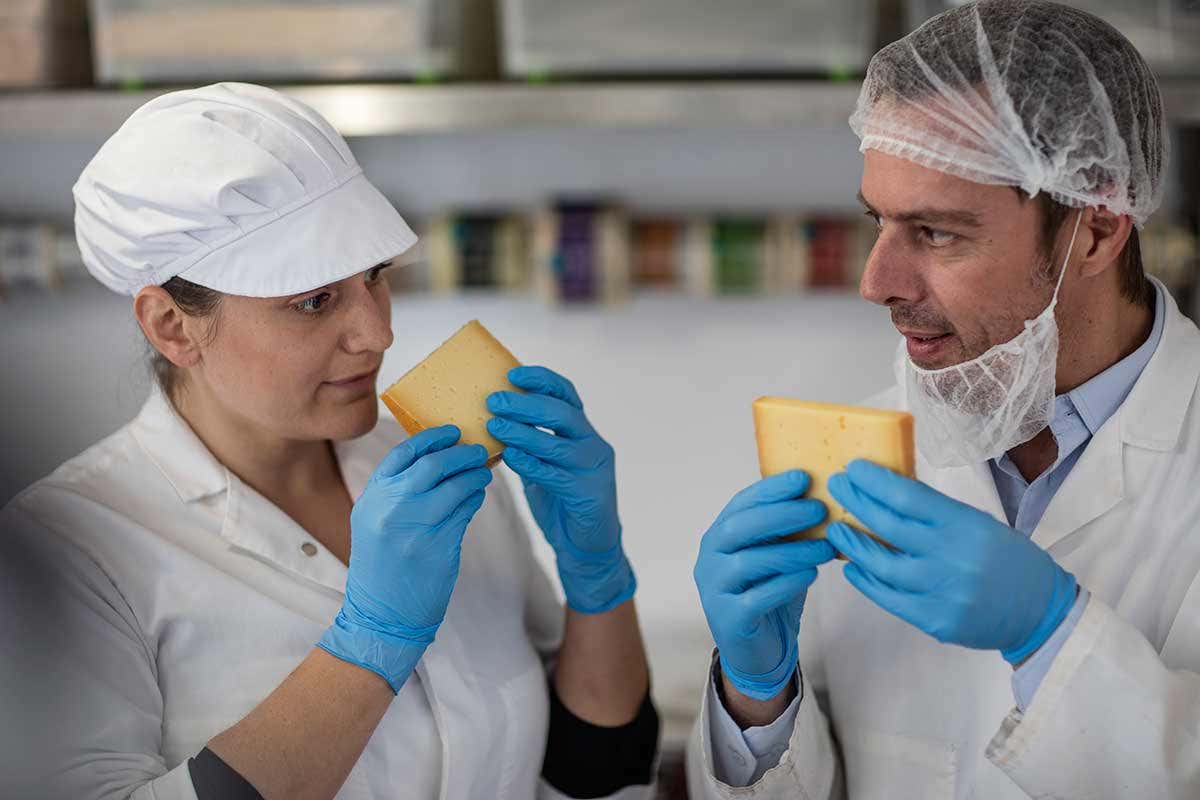 Two people smelling cheese