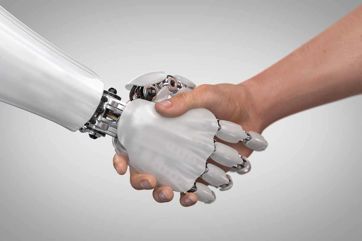 A human hand shakes a robot hand