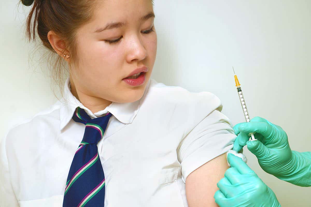 A lady gets a vaccine