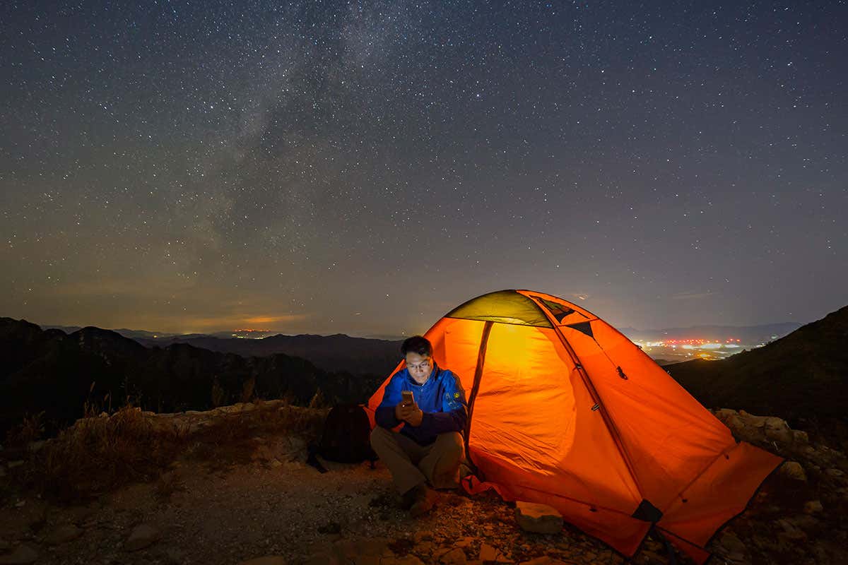 Man with tent at night