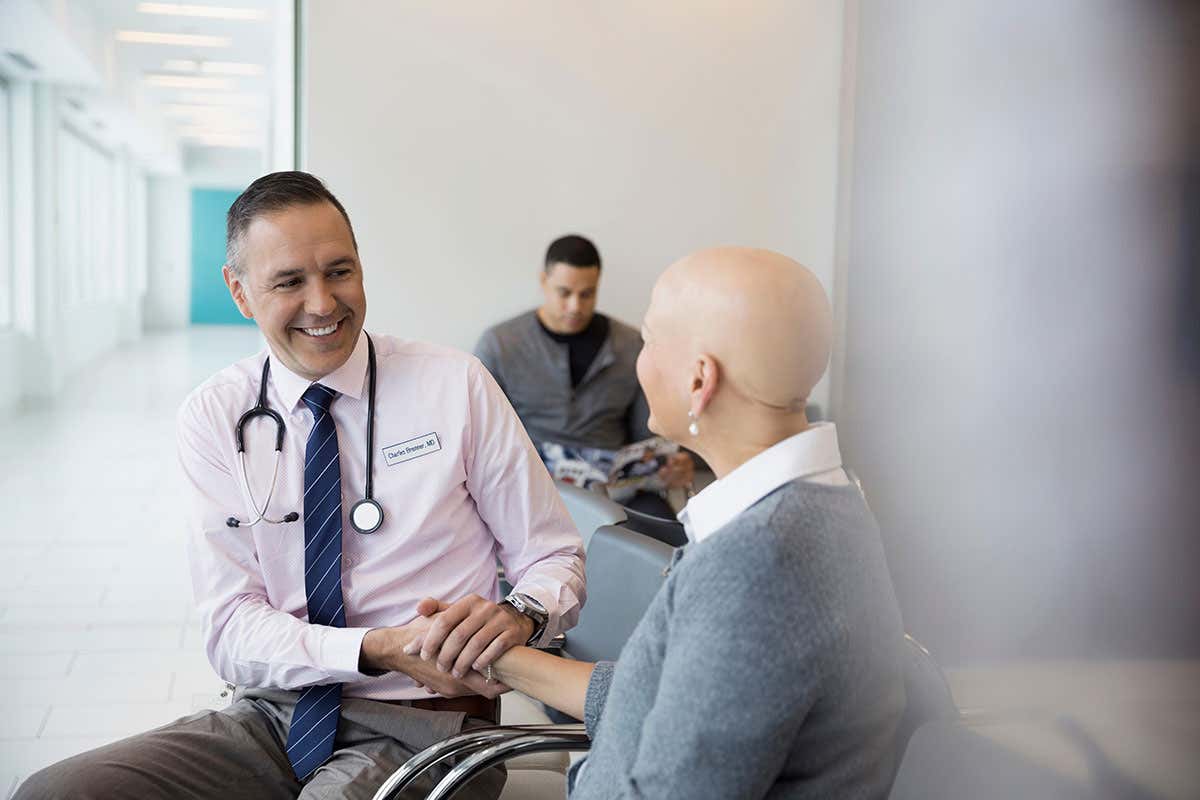A person with cancer talking to a doctor