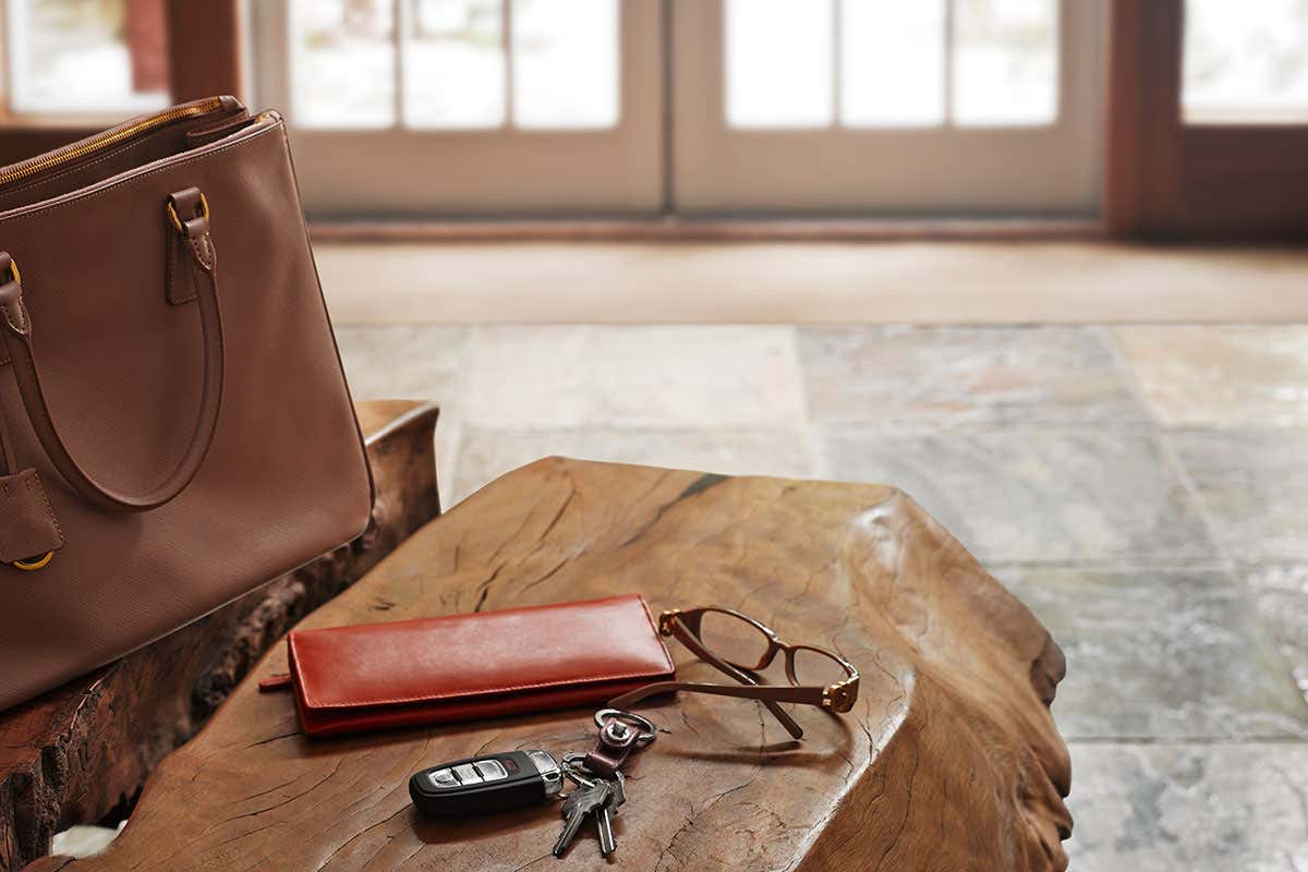 A wallet, keys, and glasses on a table