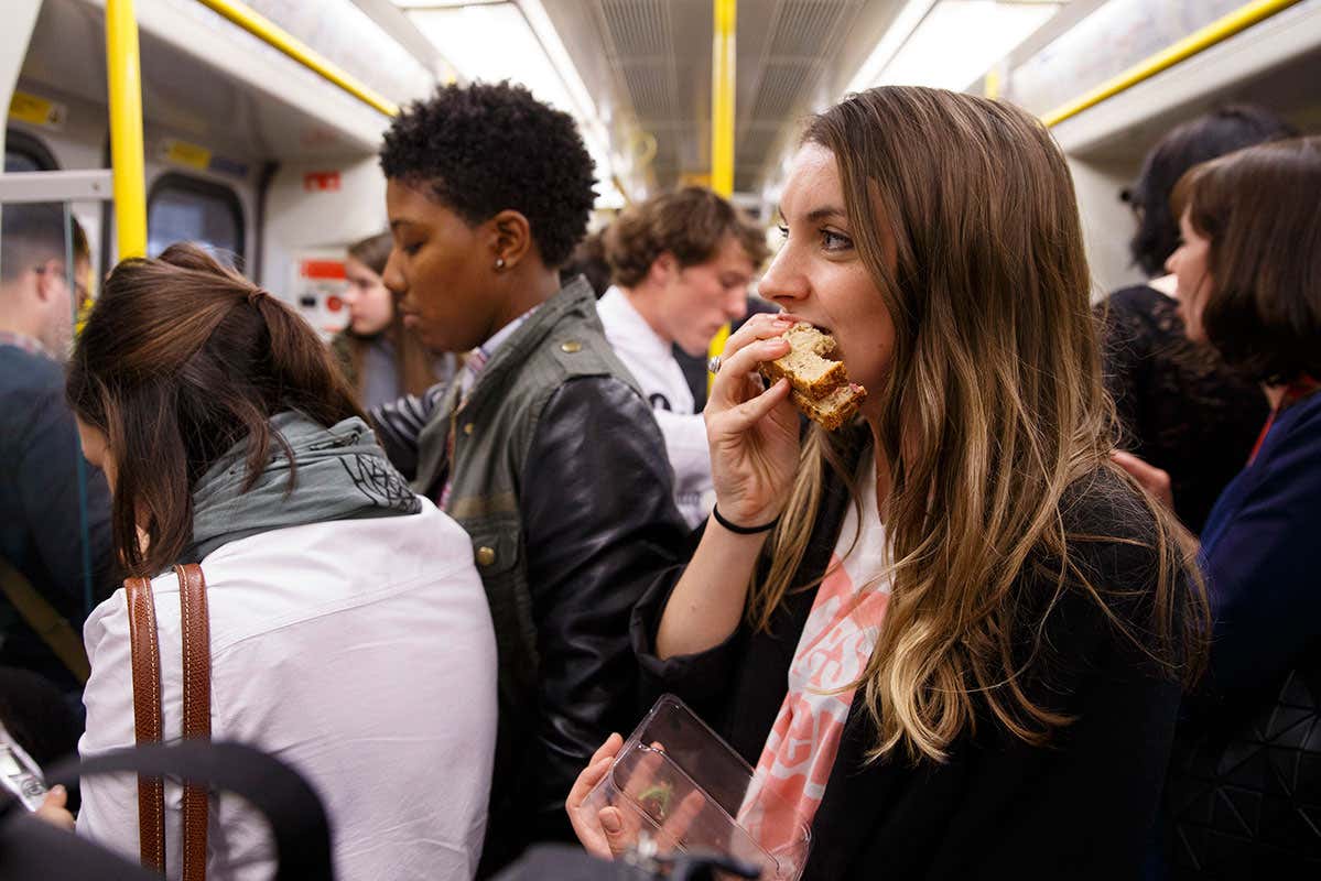 Woman eating sandwich on London underground
