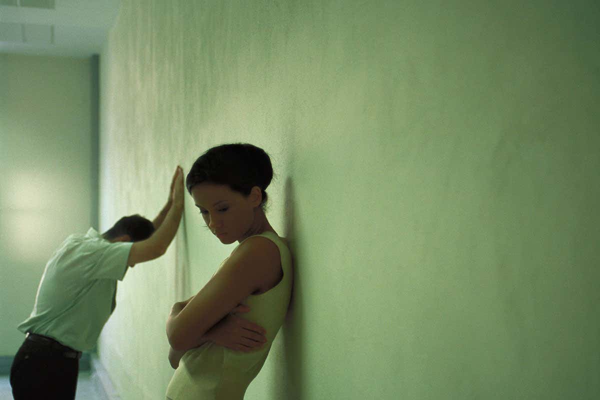 Woman leaning against wall