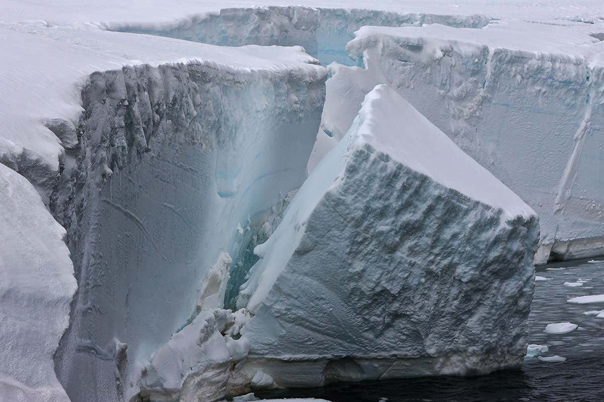 Ice calving off an ice shelf in the Antarctic.