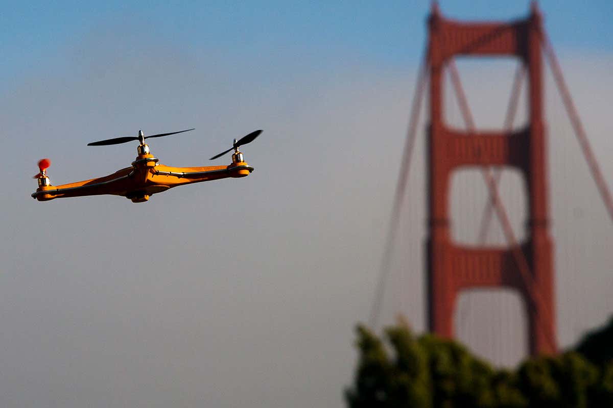 A drone flies in front of the Golden Gate Bridge .