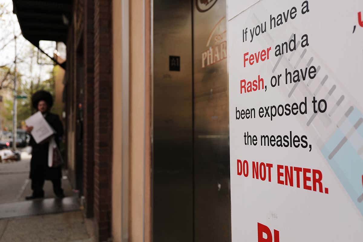 A sign warns people of measles