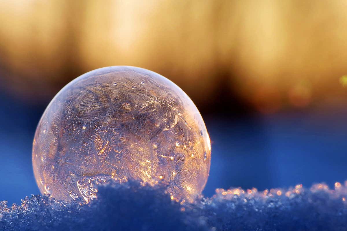 Tiny graphene sheets can start or stop ice crystals growing in water