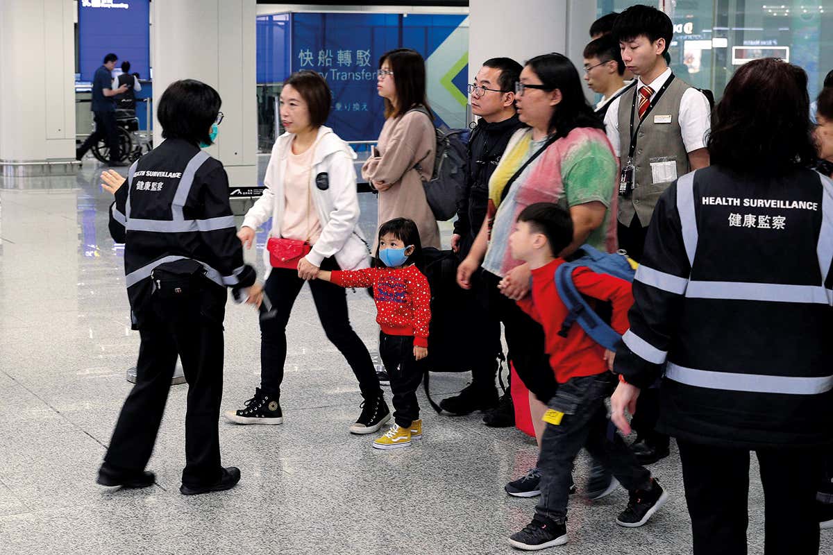 People queue at an airport