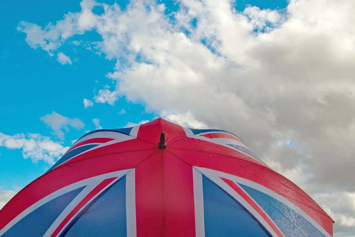 Union jack umbrella against a cloudy blue sky