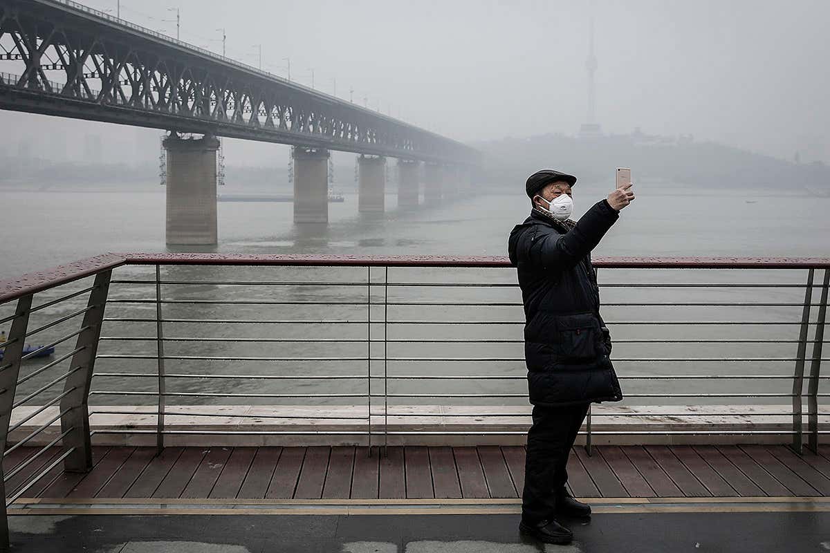 A man wears a mask near Wuhan, China