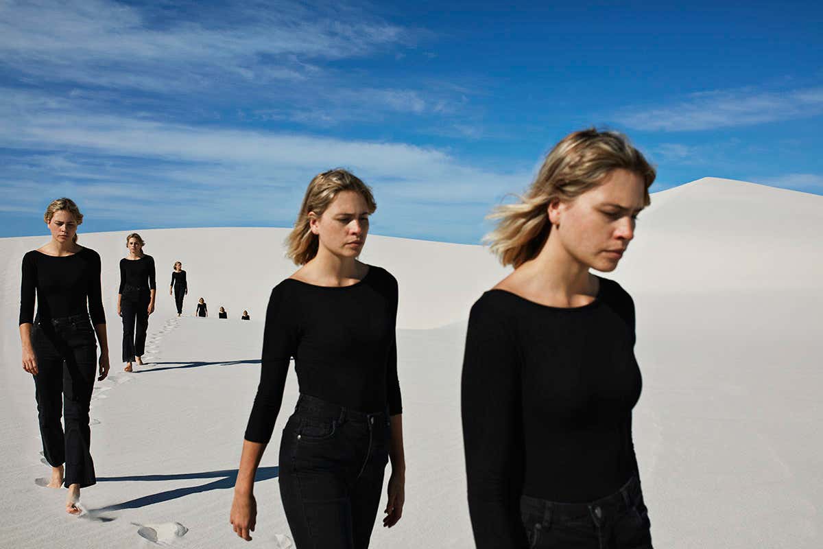 image of woman walking in desert