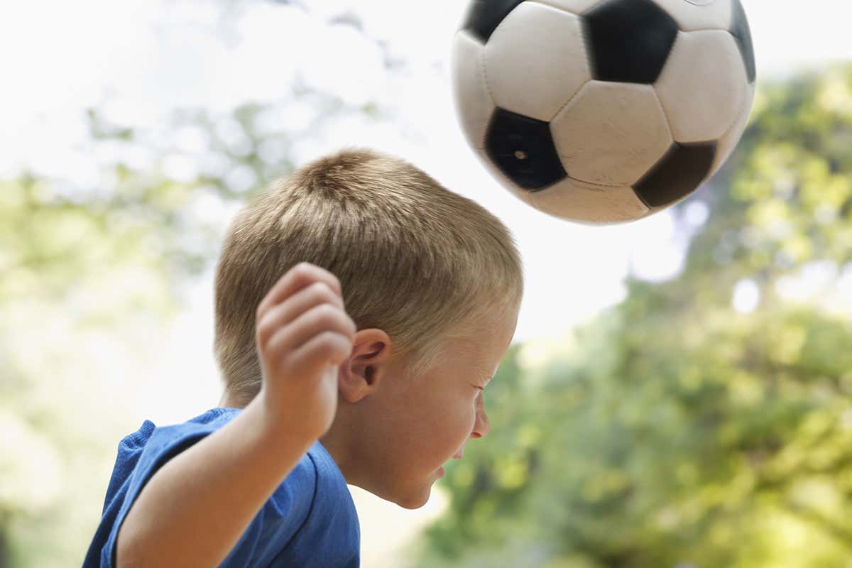 boy heading football