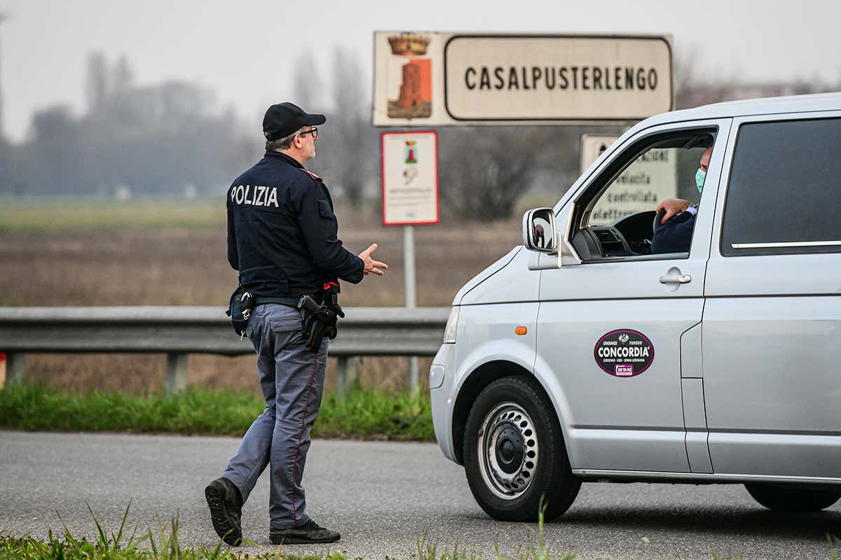 Police check movement into and out of Casalpusterlengo, Italy, as part of efforts to contain the virus