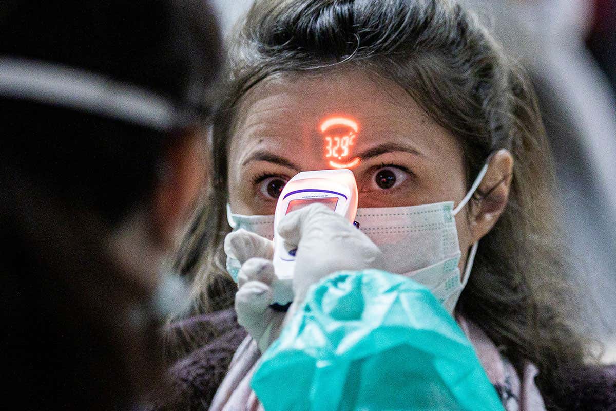 Woman having her temperature taken