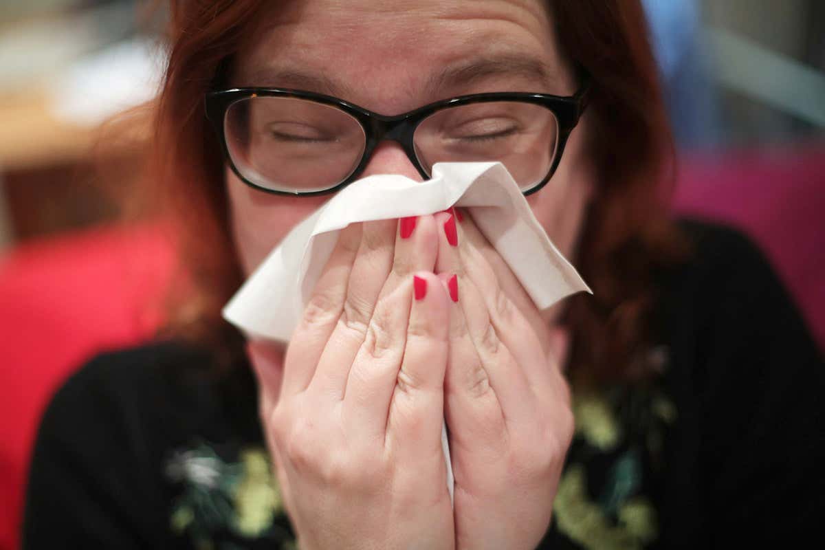 Woman blowing her nose