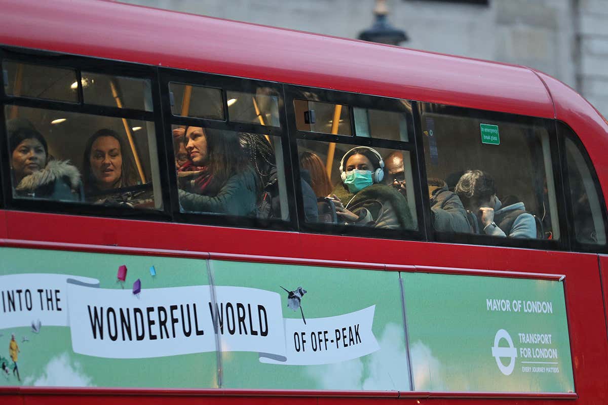 Woman with face mask on bus