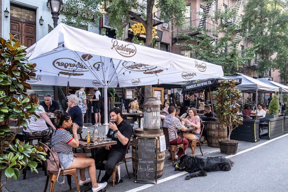 People dine outside a bar in New York