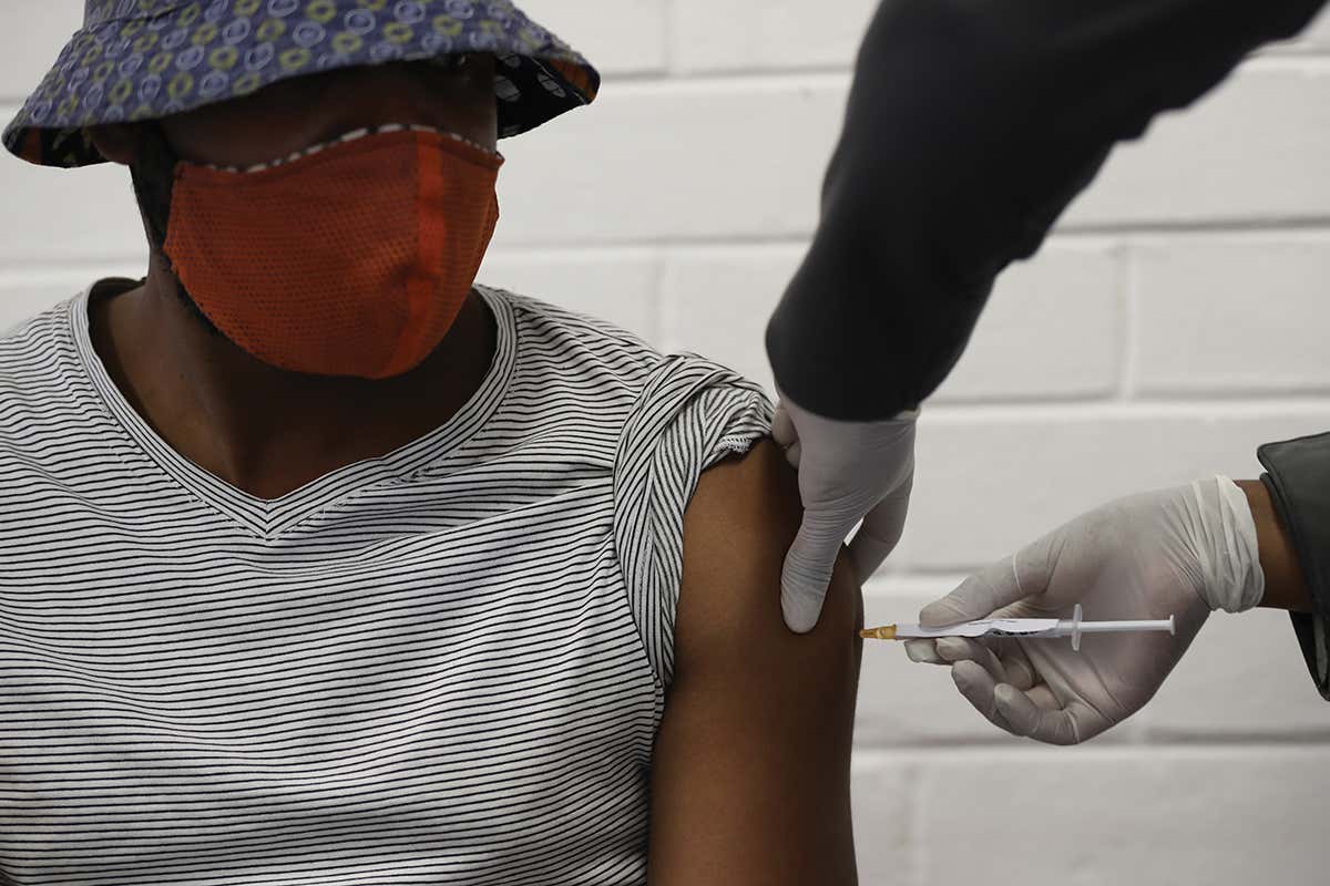 A trial participant gets injected in the arm