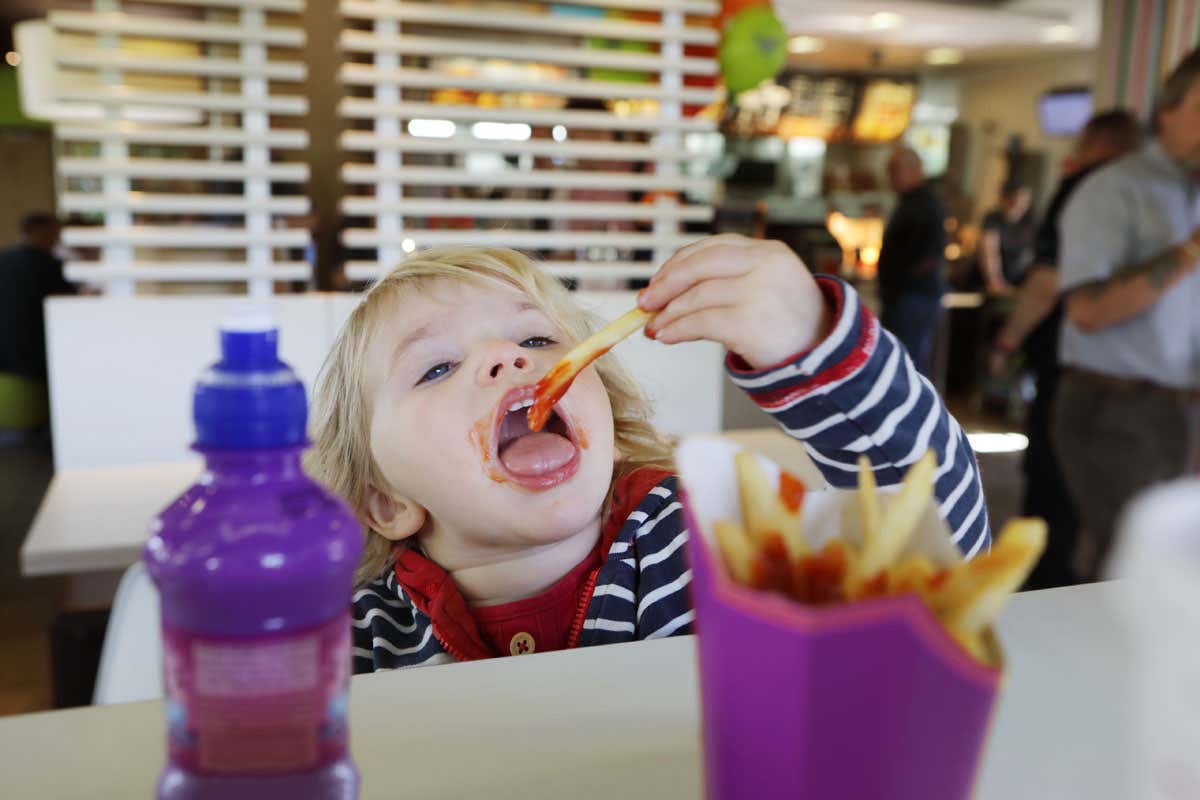 child eating fast food