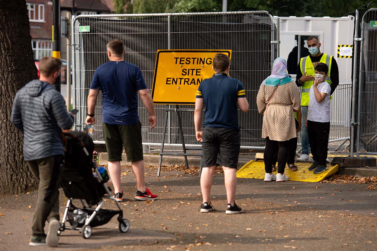 People queue at a coronavirus testing facility