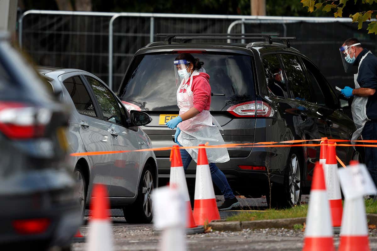 Drivers attend a coronavirus drive-in testing facility set up at the Chessington World of Adventures Resort, in Chessington, UK