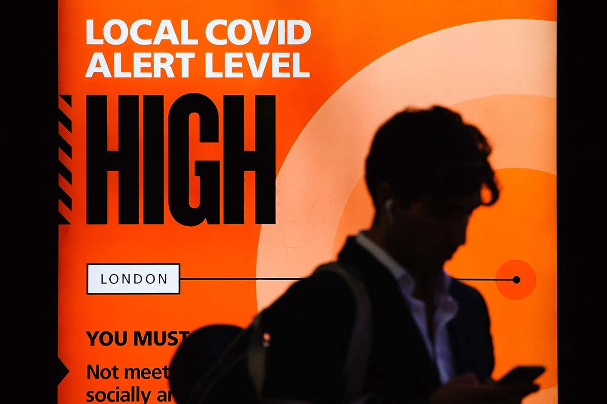 A government notice reminds people of 'high' or 'tier 2' coronavirus restrictions in London, UK