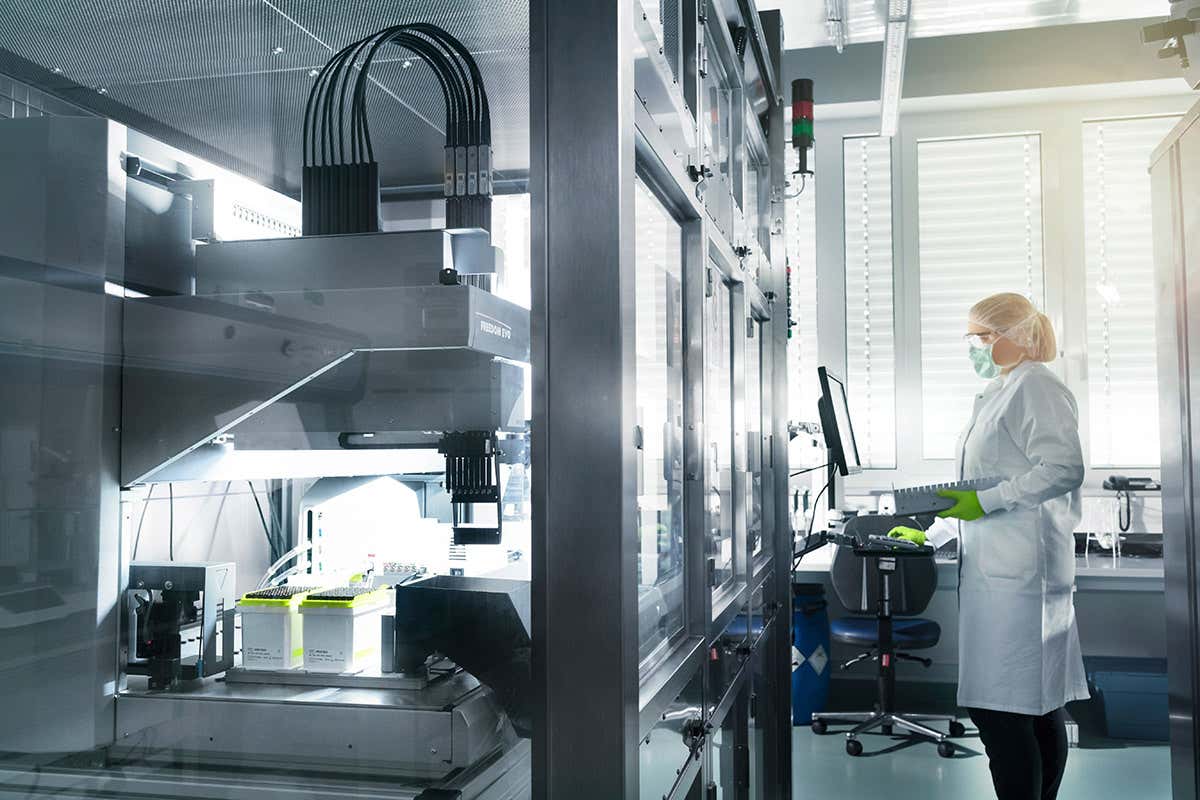 A laboratory worker wearing personal protective equipment stands in a BioNTech laboratory in Mainz, Germany