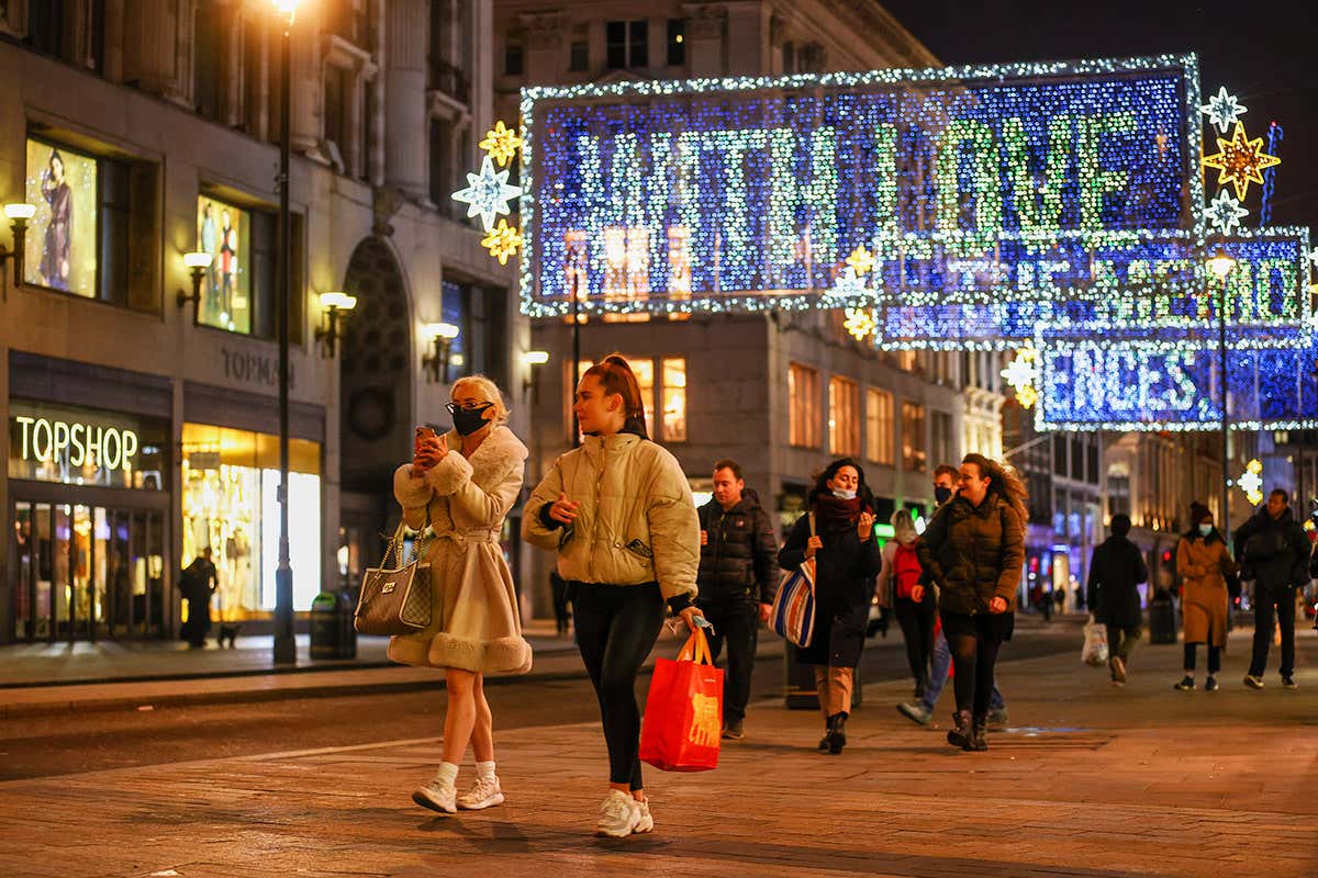 Pedestrians pass festive lights on Oxford Street in London, UK