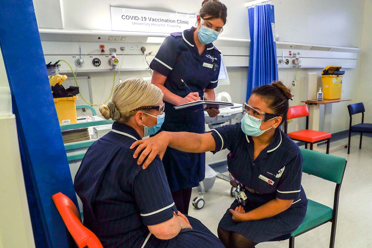 Healthcare workers training in the covid-19 vaccination clinic at the University Hospital in Coventry, England, on 4 December