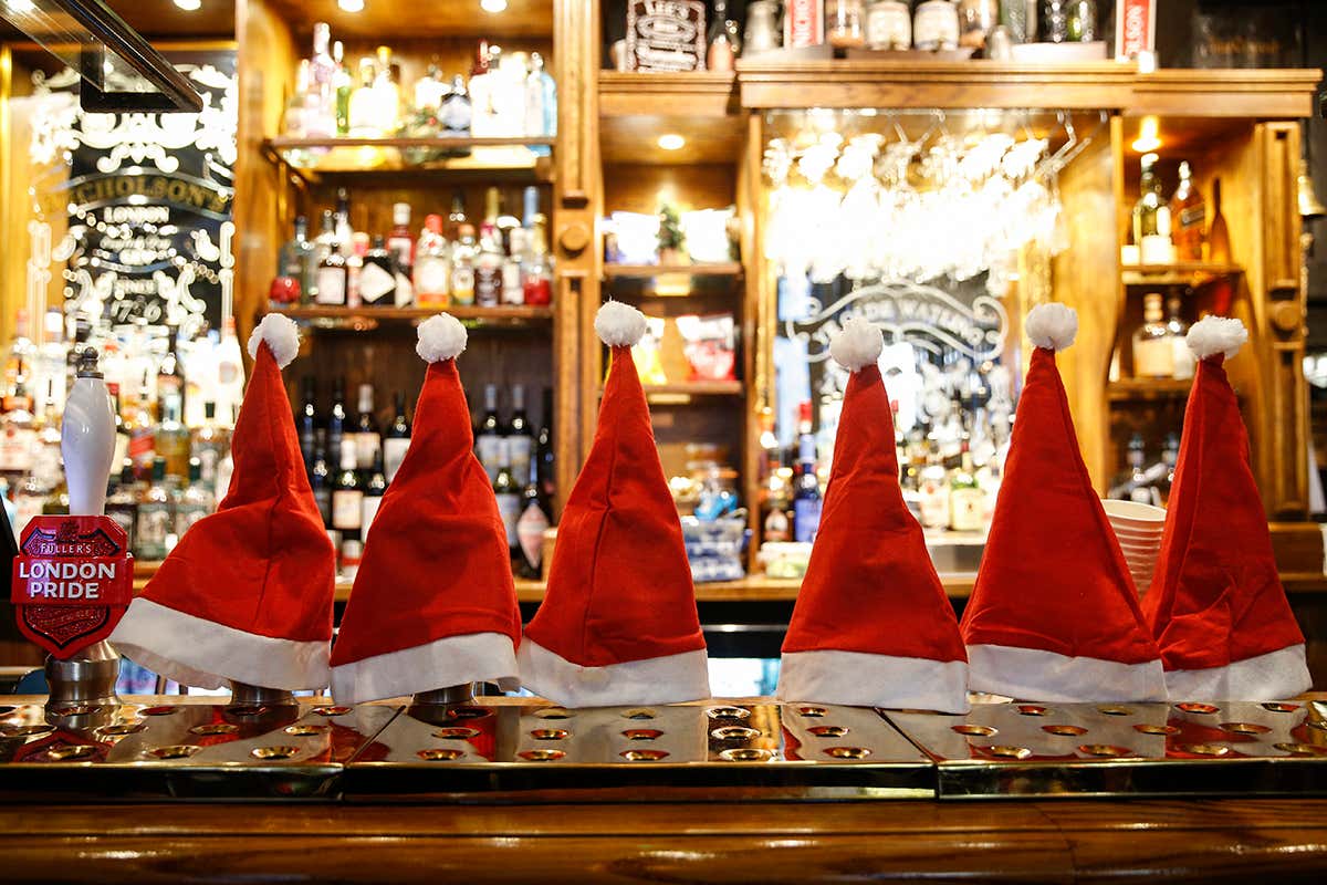  Christmas hats cover beer taps inside a pub in London, UK, on Monday 14 December