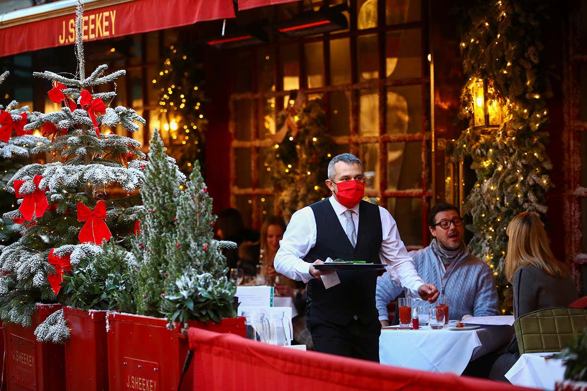 A waiter works at a restaurant in London, UK, on 15 December