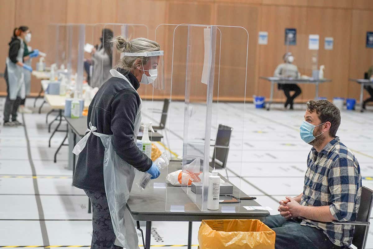 Students taking part in a mass lateral flow covid-19 testing