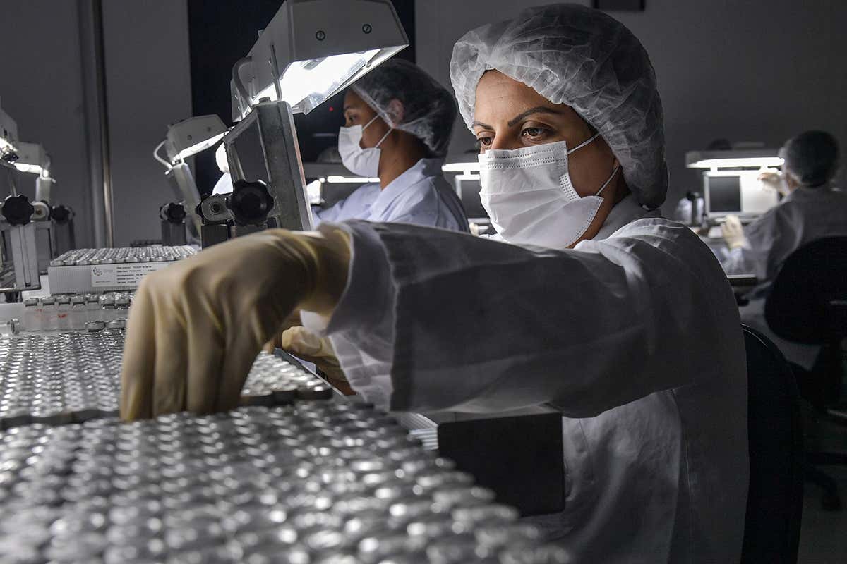 Employees work on the production line of CoronaVac, Sinovac Biotech's vaccine against COVID-19 coronavirus
