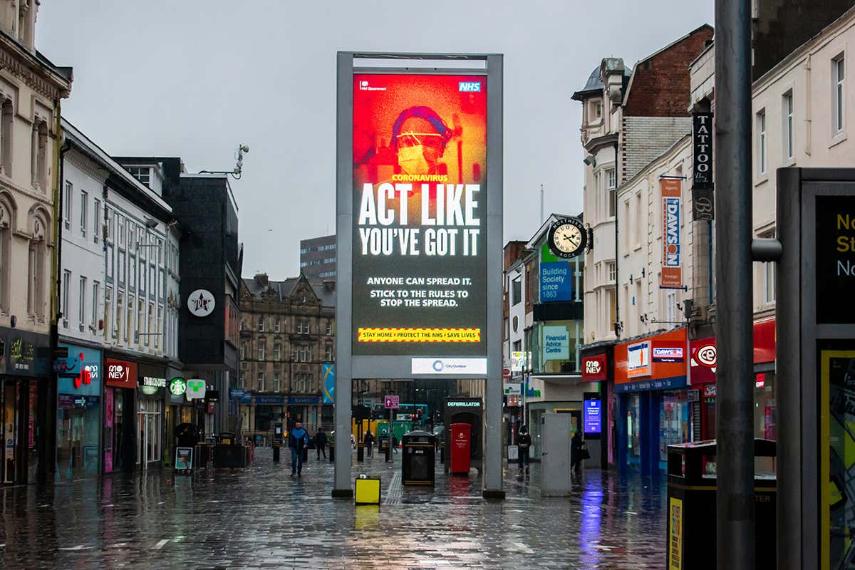 'Stay Home Save Lives' publicity campaign poster in Newcastle upon Tyne, England
