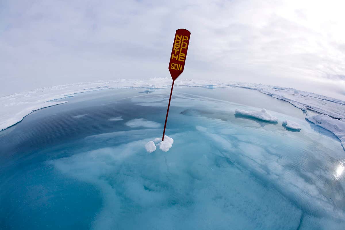North Pole sign in melting ice and meltwater